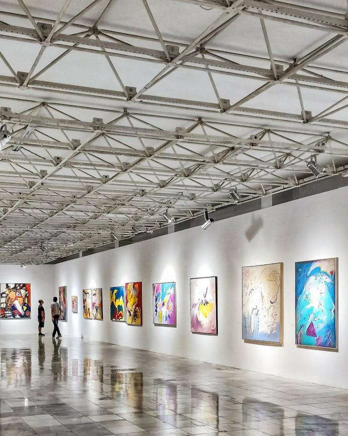 our-services-3 Explore a contemporary art exhibition in an elegant Brazilian gallery with vivid paintings.